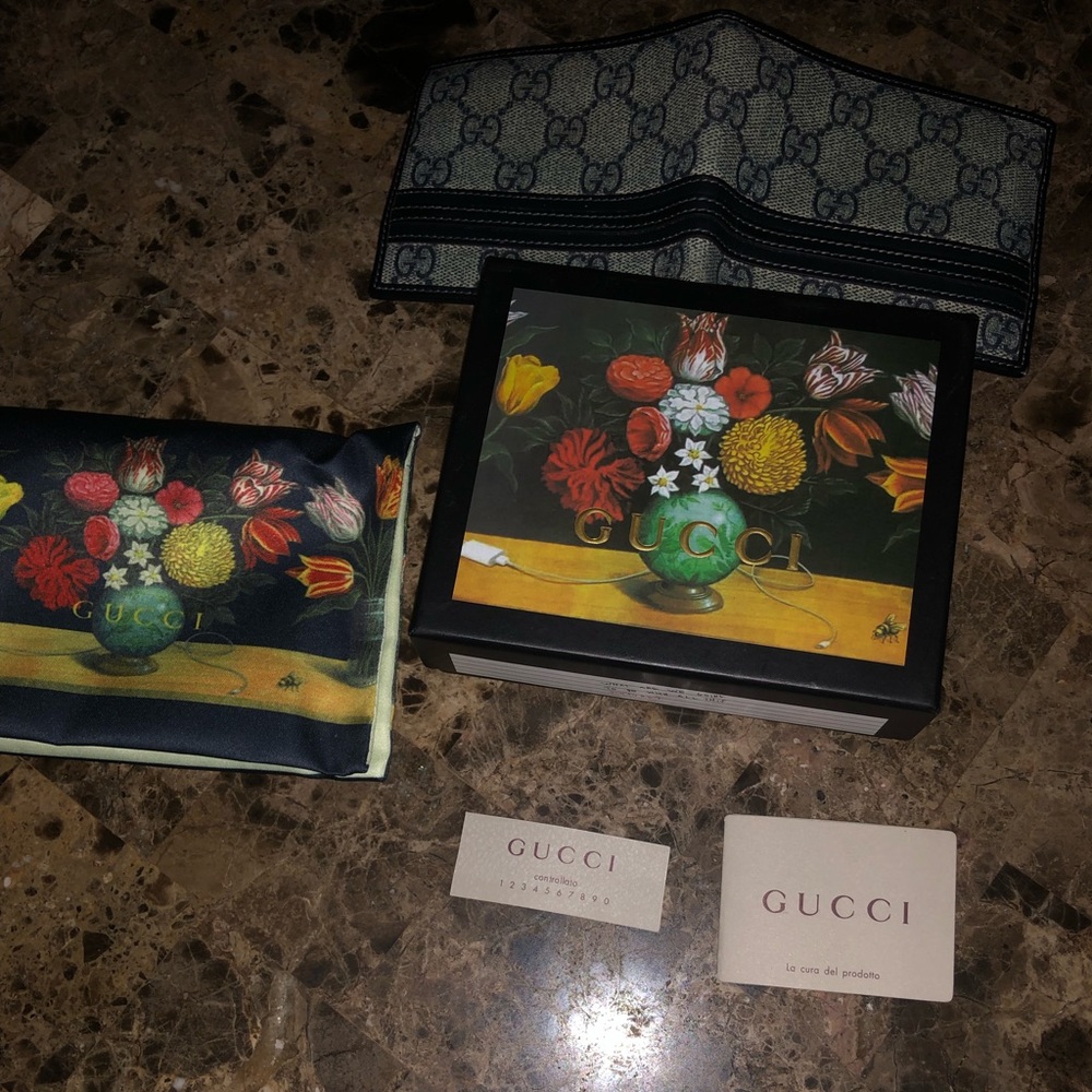 Blue Gucci Supreme wallet.